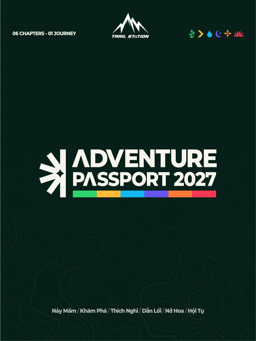 Bìa trước Passport mới nhất: logo Adventure Passport 2027, dải sáu màu và đường đồng mức trên nền xanh đậm